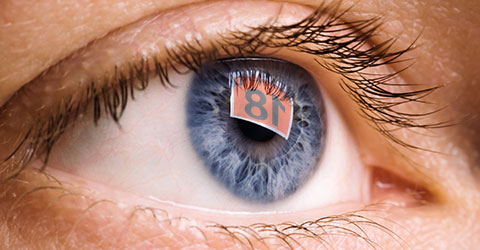 R18 label reflected in a person's eye from a computer screen