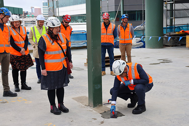 Ngā Taonga Sound Honiana Love performs karakia while Hoani Lambert trowels freshly poured concrete at the topping out of the new archival building. Credit: Max Olijnyk/Te Tari Taiwhenua.