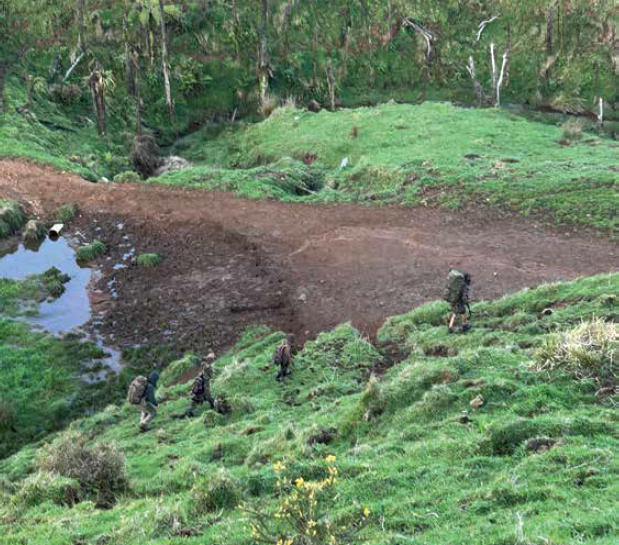 Still image from video taken by pig hunters of Tom Phillips and the children on 3 October 2024 with the four figures walking across a hillside. Still image from video taken by pig hunters of Tom Phillips and the children on 3 October 2024 with the four figures walking across a hillside.